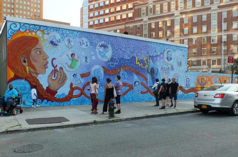 The completed mural catches the eyes of many community members. The team worked hard to visually challenge its onlookers to think about and celebrate female strength and solidarity.